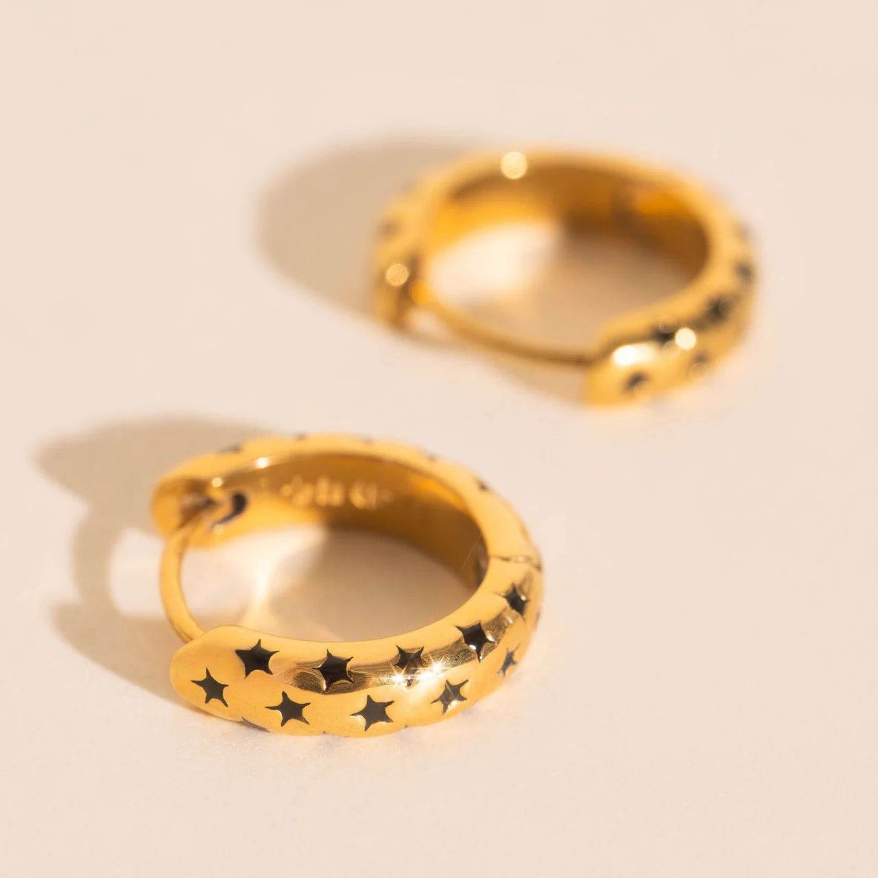 Black Star Chunky Huggie Hoop Earrings - Image 2