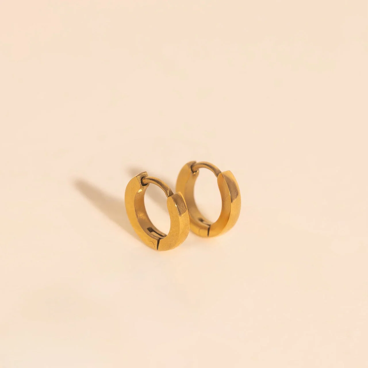 Smooth Tiny Huggie Hoop Earrings - Image 2