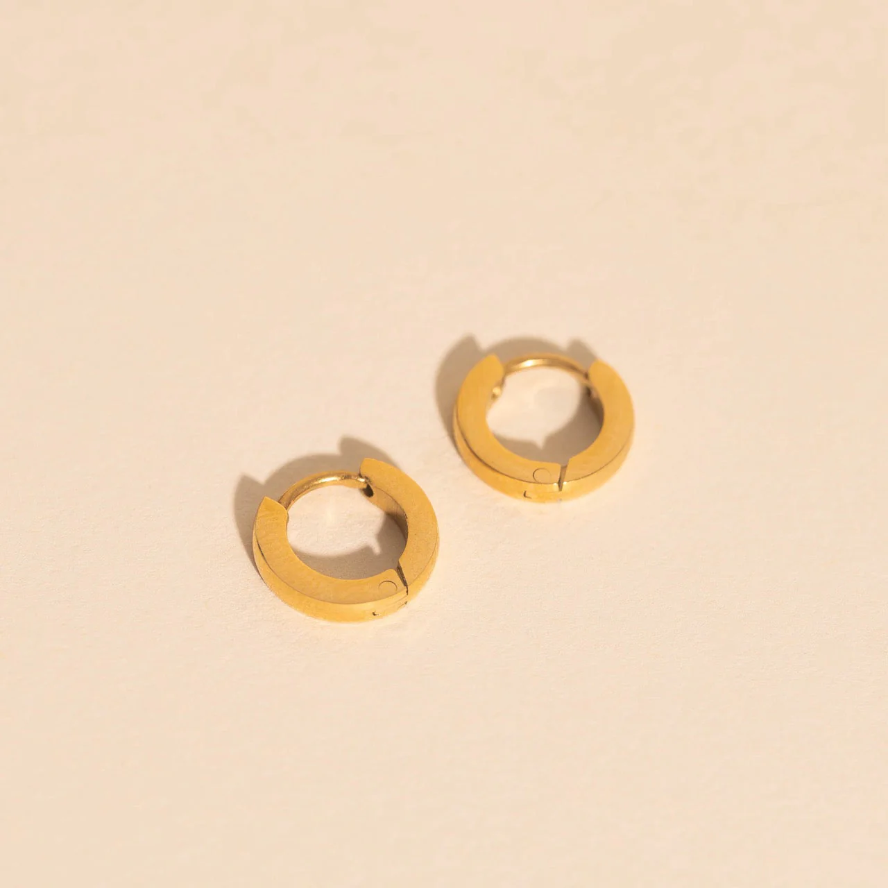 Smooth Tiny Huggie Hoop Earrings - Image 4