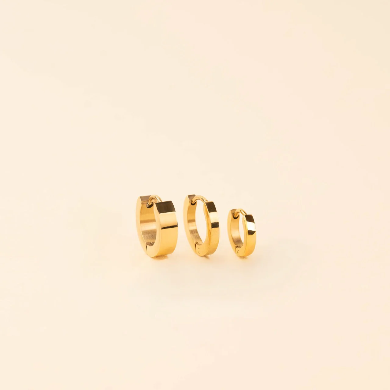 Smooth Tiny Huggie Hoop Earrings - Image 9